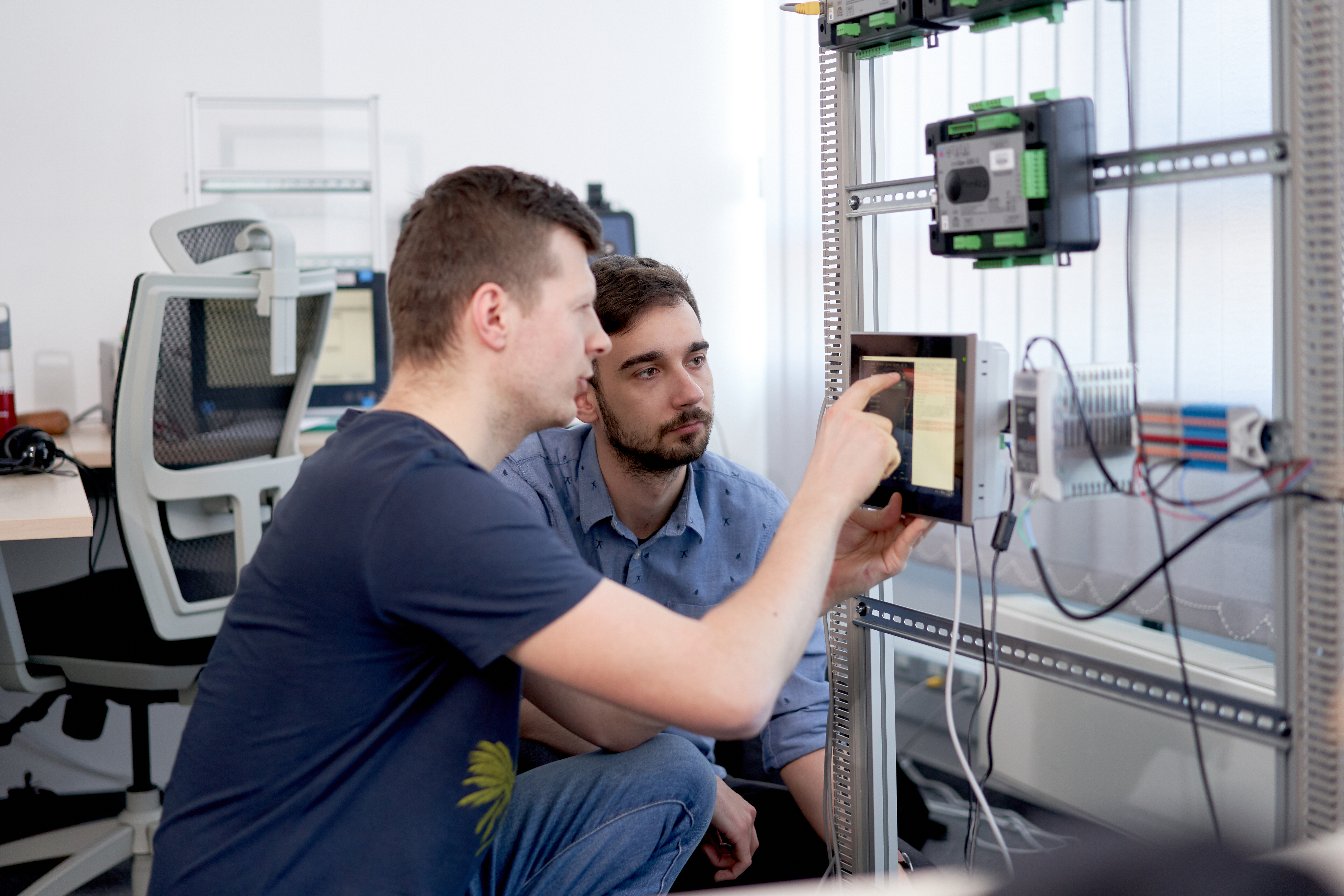 Testers working at ComAp on controllers and displays.